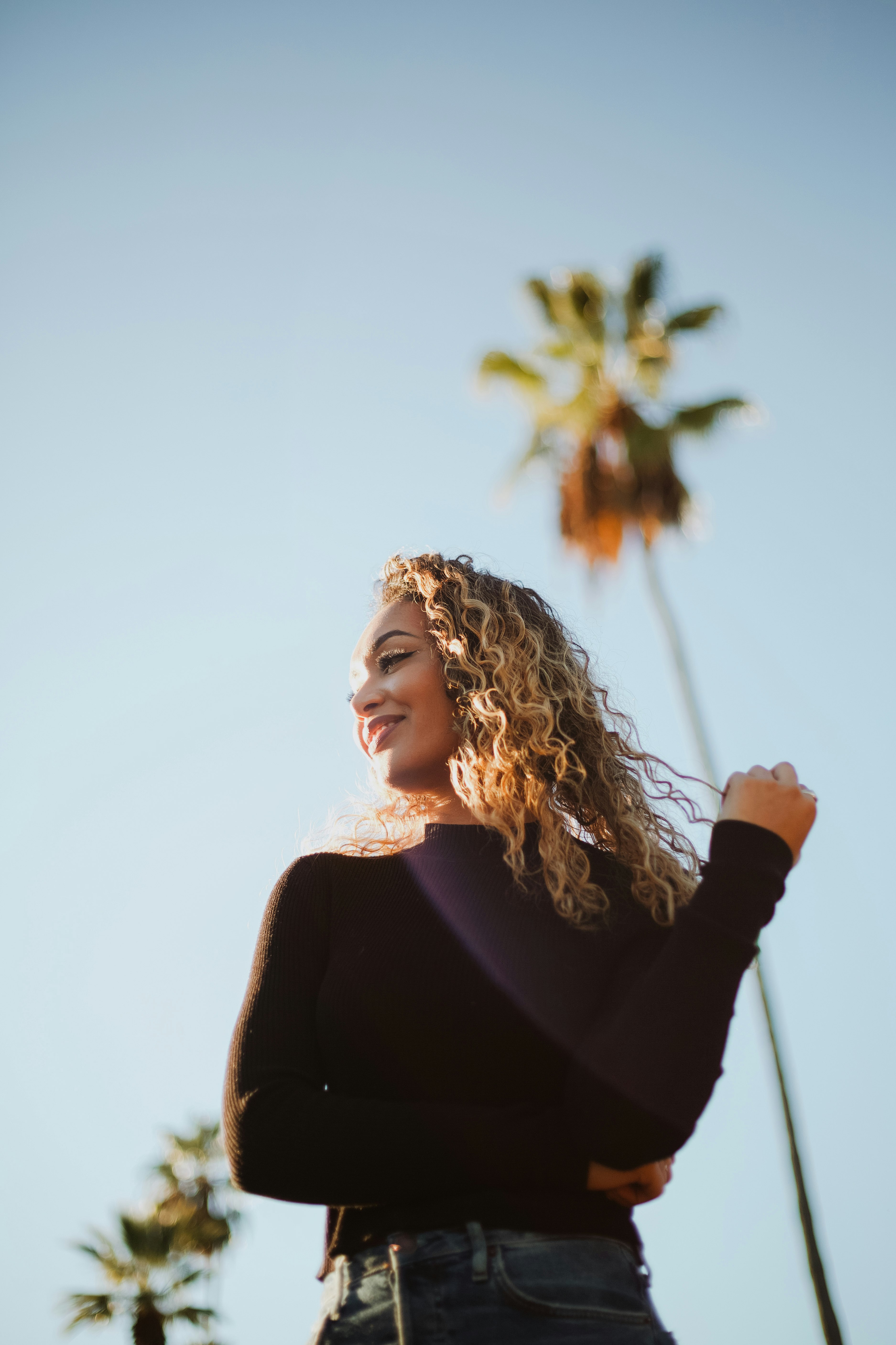 close-up photography of smiling woman near outdoor during daytime